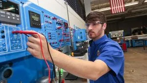 Photo of student working with machine in Industrial Systems Technology