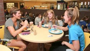 Photo of students eating in the Food Service area of the Campus View Housing complex