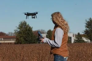 Picture of Ag student flying drone over field