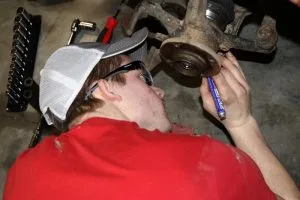 Picture of automotive student working on car